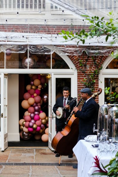 Don Vappie Trio performing for guests in the courtyard